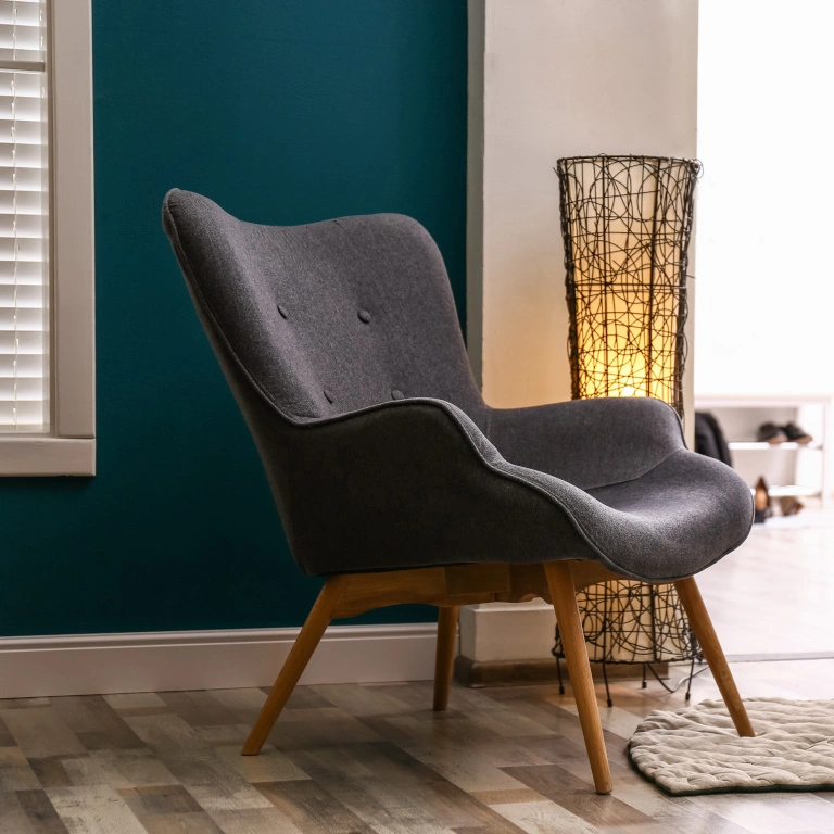 A comfortable chair in a furnished, rented home